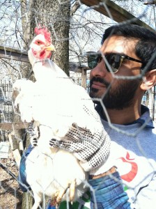 One of our former student staff members, Hasin, holding a chicken during Hands On New York Day.